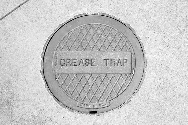 foul odors, slow drainage, and excessive grease buildup are signs that your grease trap needs pumping